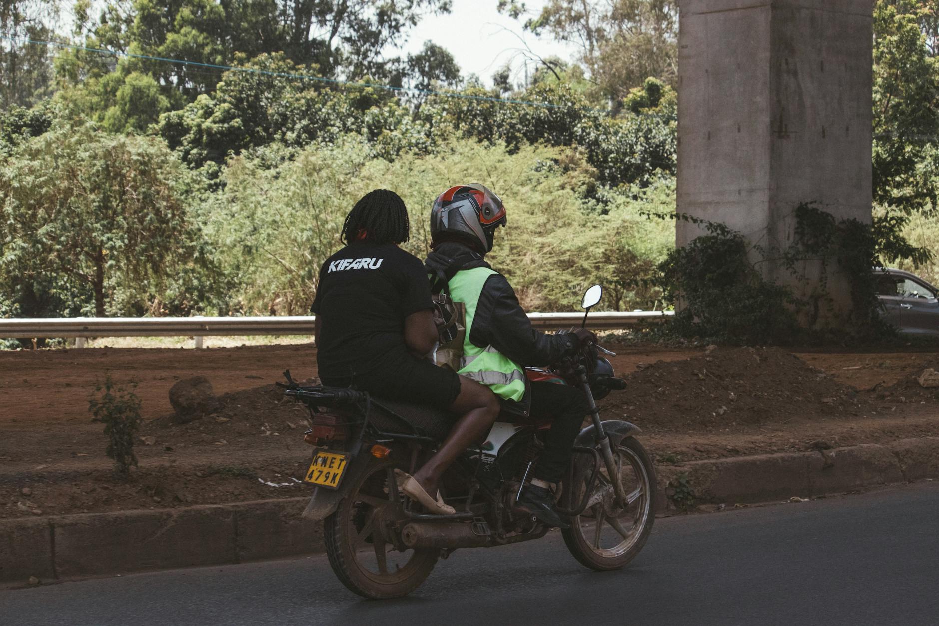 Kenyan driver switching to digital motor insurance on a smartphone, showing policy details.