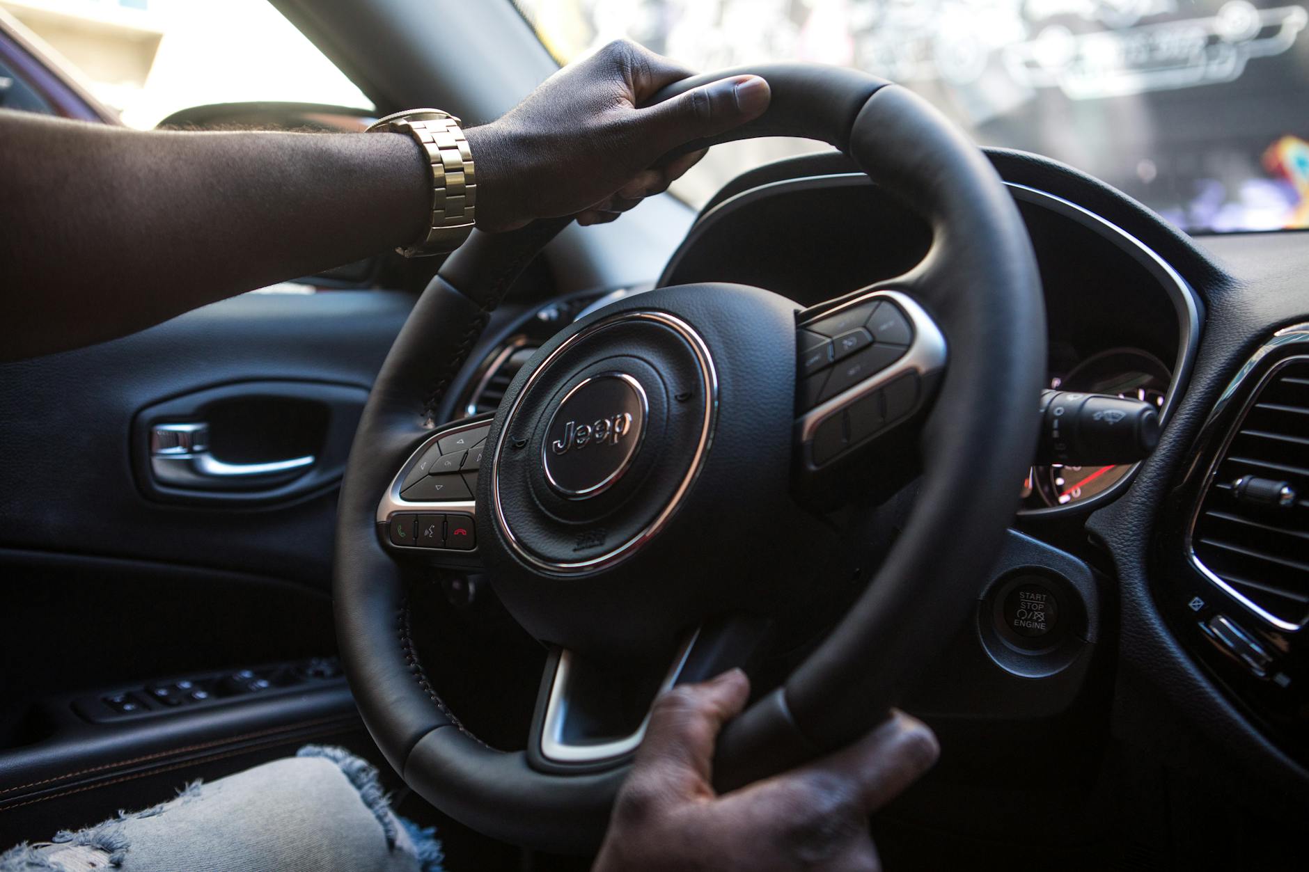 A driver holds a phone showing "Ruiru drivers insurance" on a screen.