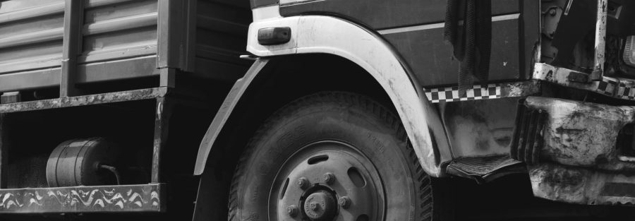 Commercial vehicle driving on road with insurance document overlay for affordable coverage in Kenya.